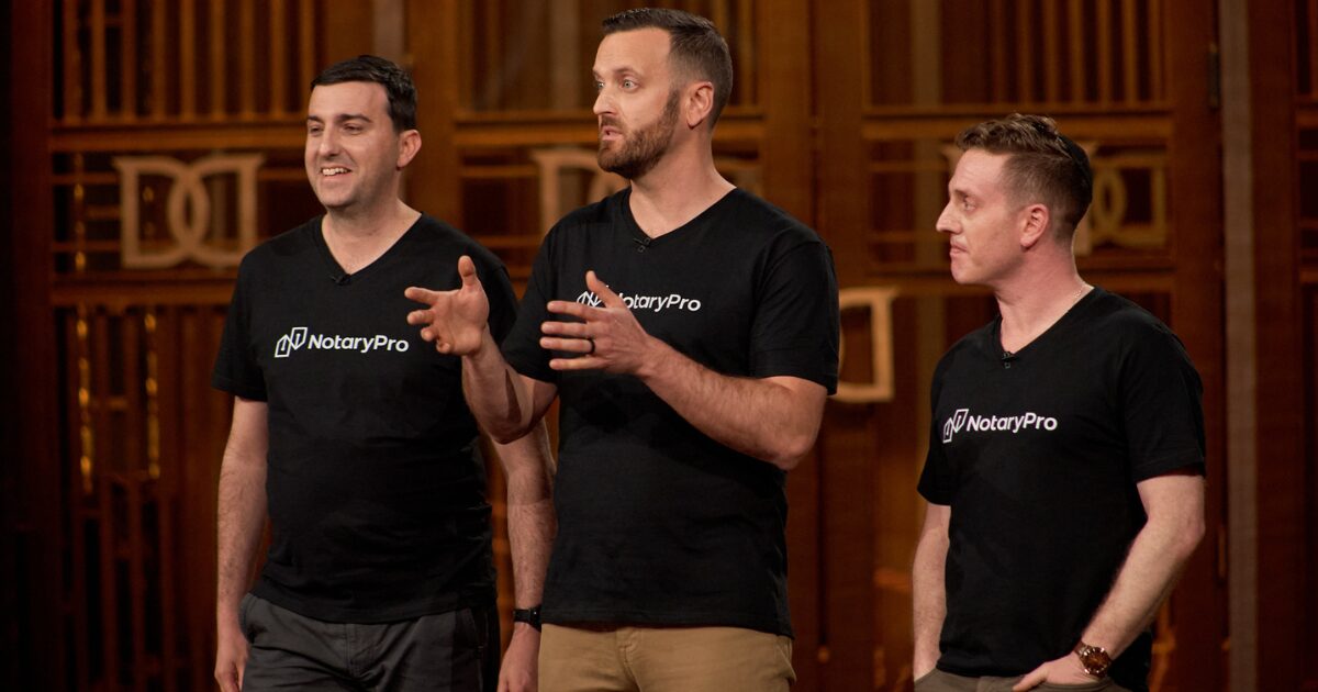 3 young male NotaryPro executives pitching on the Dragons' Den stage.